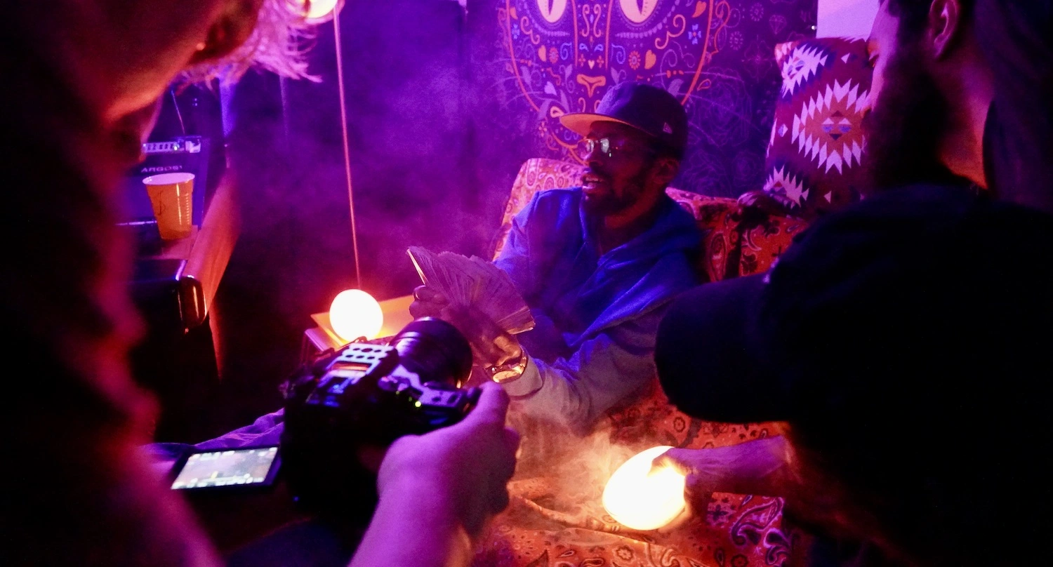 Camera recording rapper smoking in studio